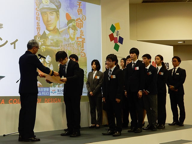 大阪海上保安幹部から感謝状を受けとる学生たち